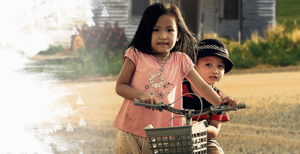 two aboriginal kids with a bike